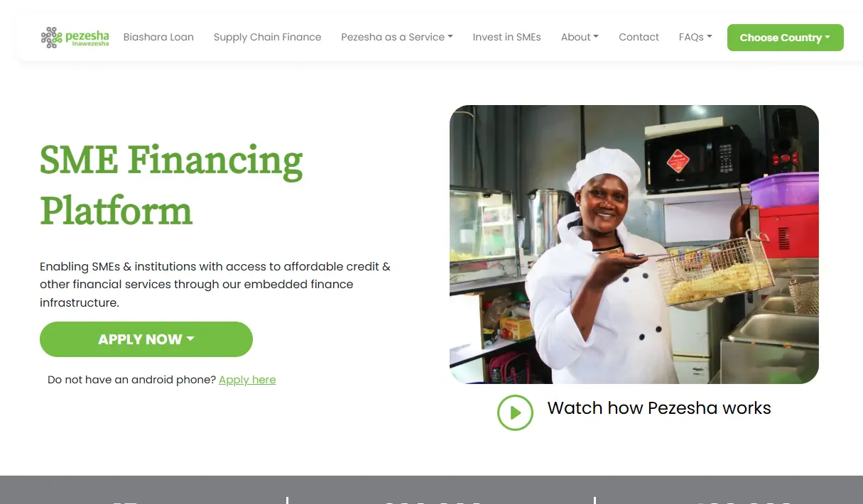 Homepage of Pezesha website featuring 'SME Financing Platform' headline. Smiling chef in a kitchen holding a tray of baked goods. Button reads 'Apply Now.'