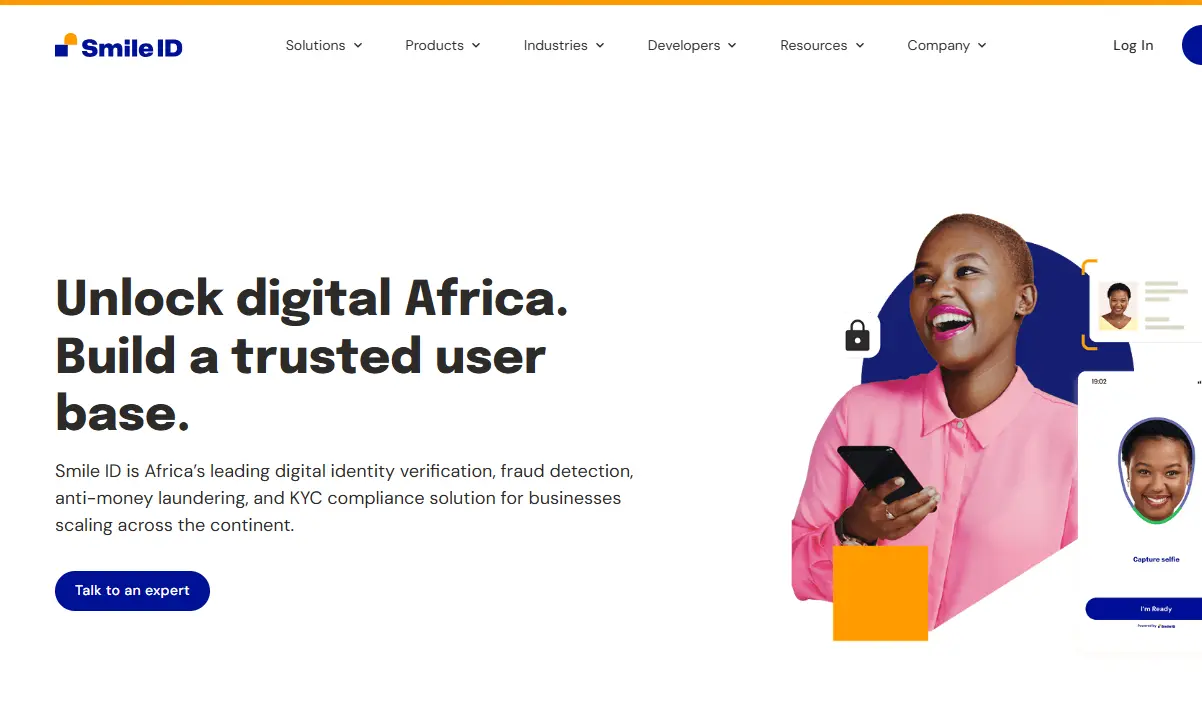 Website header for Smile ID, featuring a smiling woman in pink holding a smartphone. Text promotes digital identity solutions in Africa.