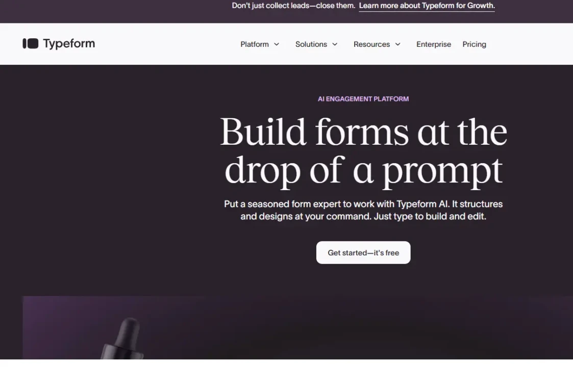 Typeform webpage with a dark background and bold text stating 'Build forms at the drop of a prompt.' Emphasizes AI integration and ease of use. Includes a call-to-action button saying 'Get started—it's free.' Website navigation options visible at the top.
