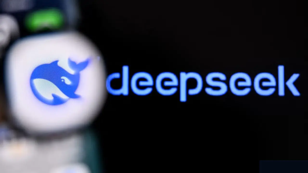 Blurry smartphone screen displaying whale app icon in focus, with the word "deepseek" in glowing blue on a dark background. Tech and innovation theme.