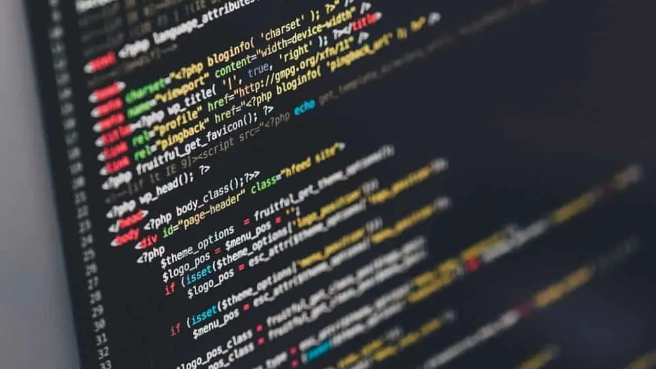 Close-up of a computer screen showcasing colorful PHP code against a dark background, symbolizing programming and web development.
