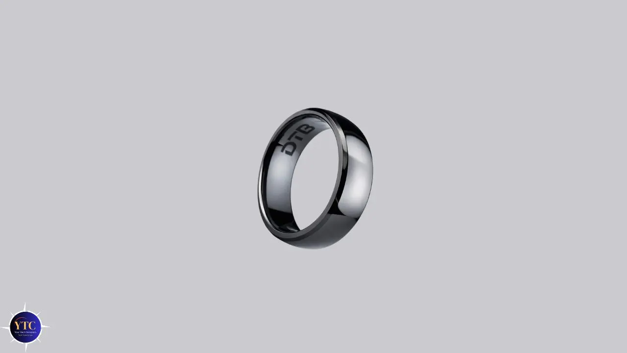 Sleek black ring with a reflective surface on a light gray background. The ring has engraved text inside, conveying a modern and elegant tone.