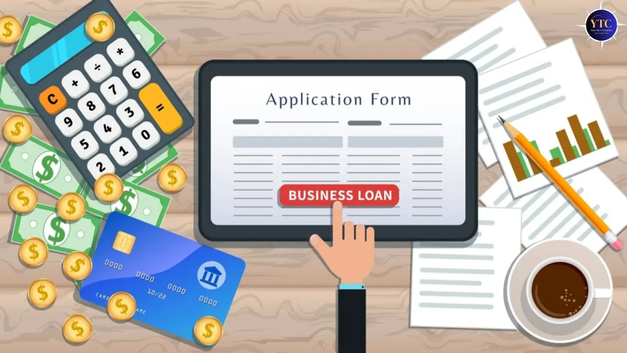 A hand pointing at a tablet screen showing a business loan application form. Surrounding items include a calculator, cash, coins, credit card, documents, and coffee, conveying a financial theme.