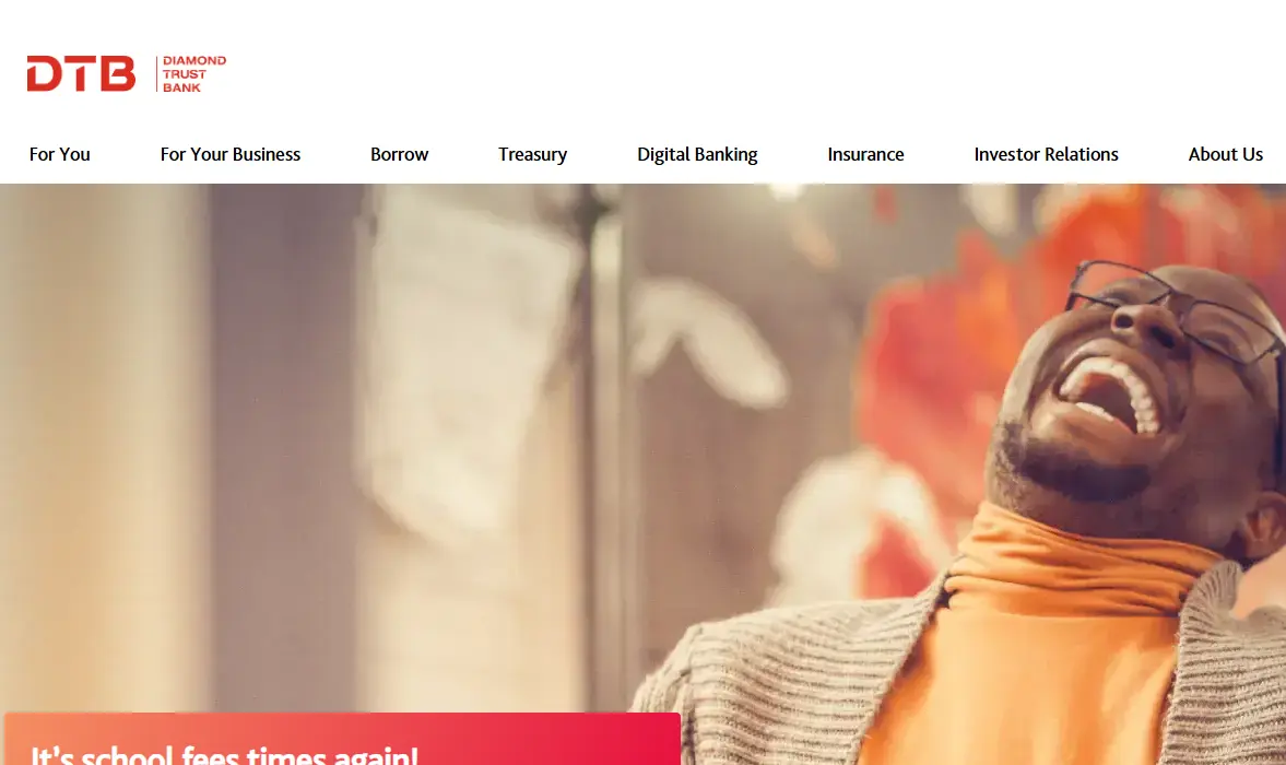 A person with glasses is joyfully laughing, wearing a turtleneck sweater. The Diamond Trust Bank website header and navigation menu are visible above.