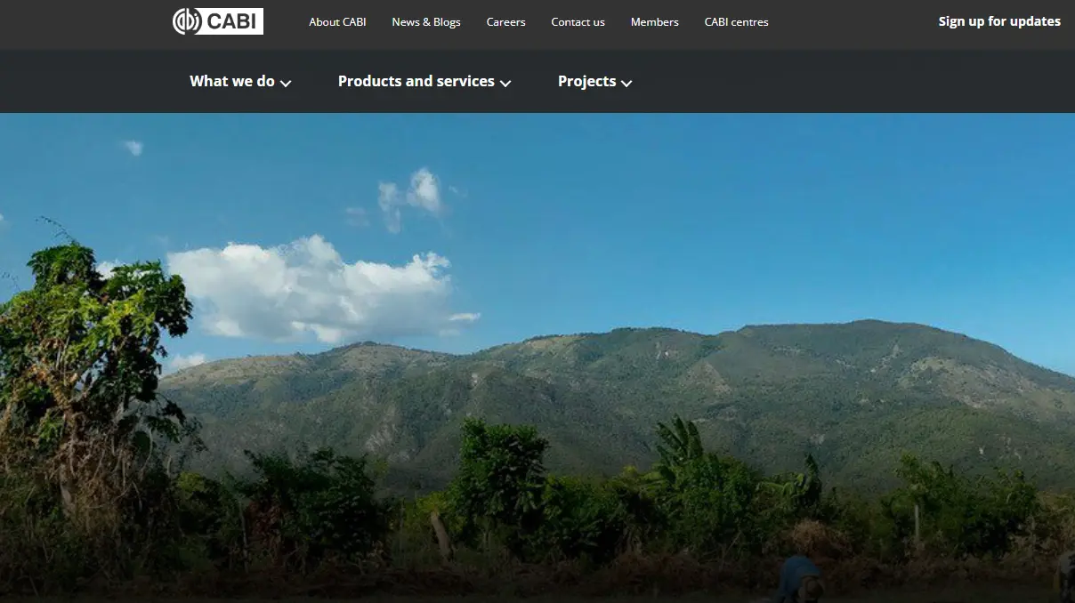 Website homepage with a landscape background of green mountains under a blue sky and CABI logo and navigation bar.